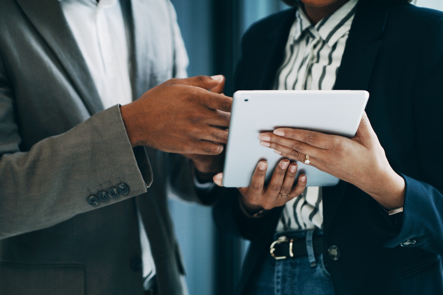 Technology being demonstrated to a coworker on an ipad