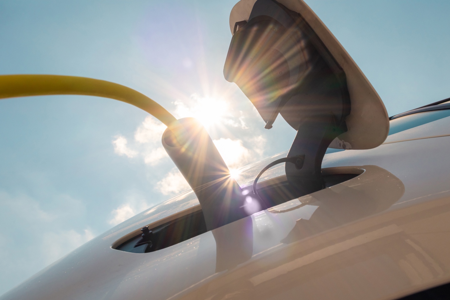 An electric car being charged representing Tesla's underperformance over FY2024