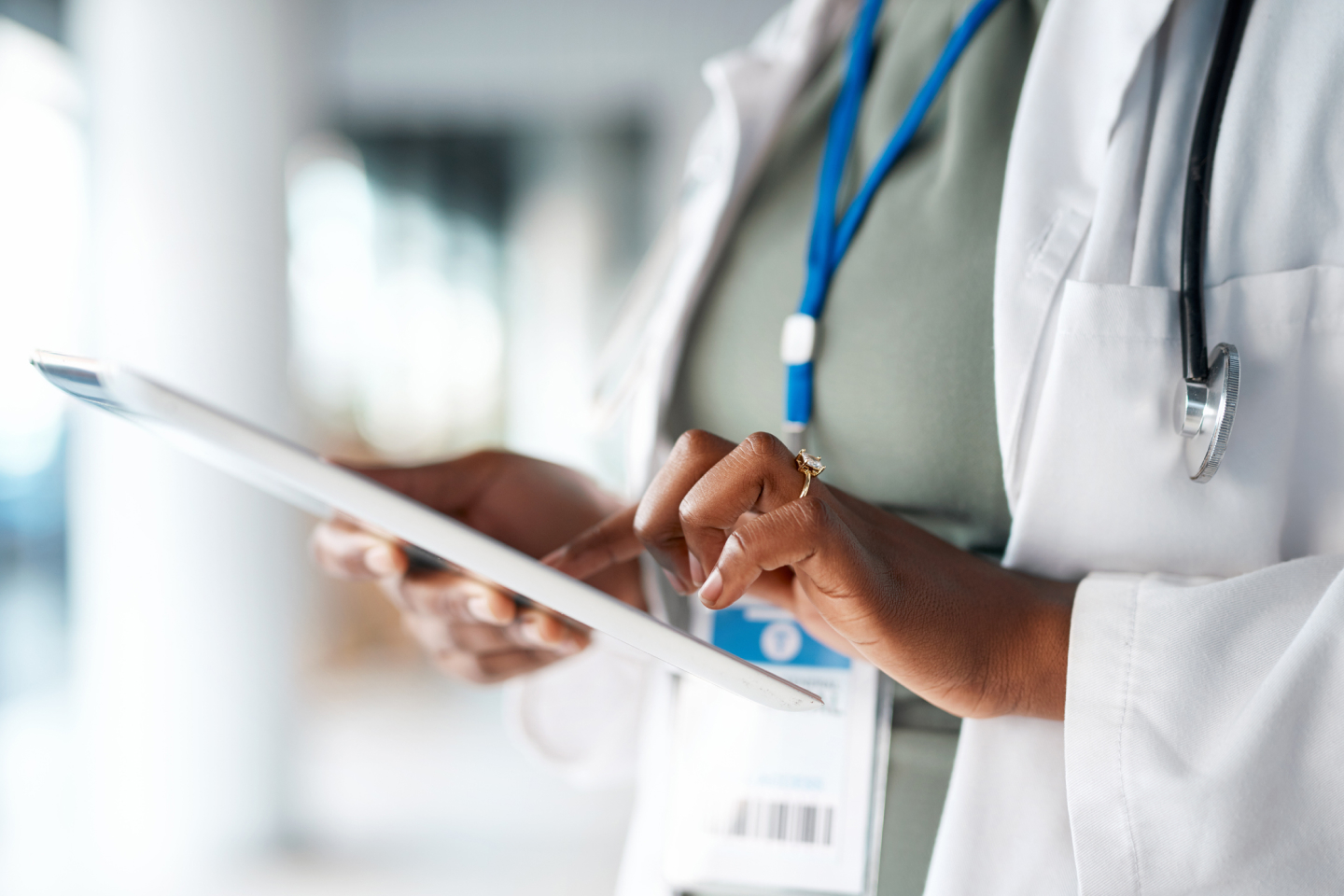 Medical professional in a lab coat with a clip board assessing someone for health insurance coverage