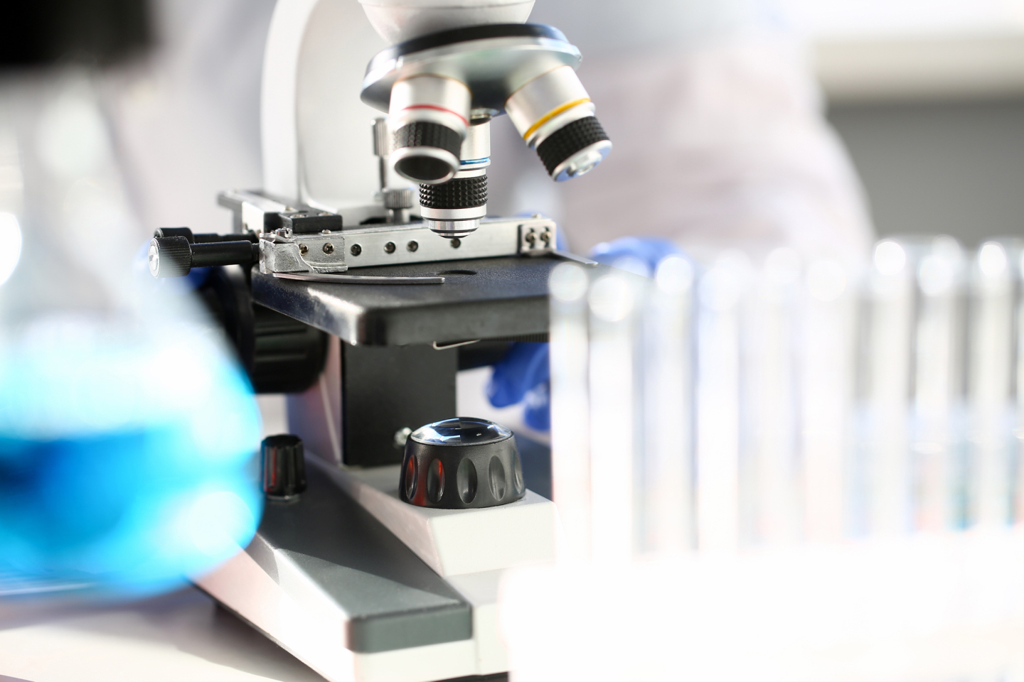 Person looking through a microscope in the lab