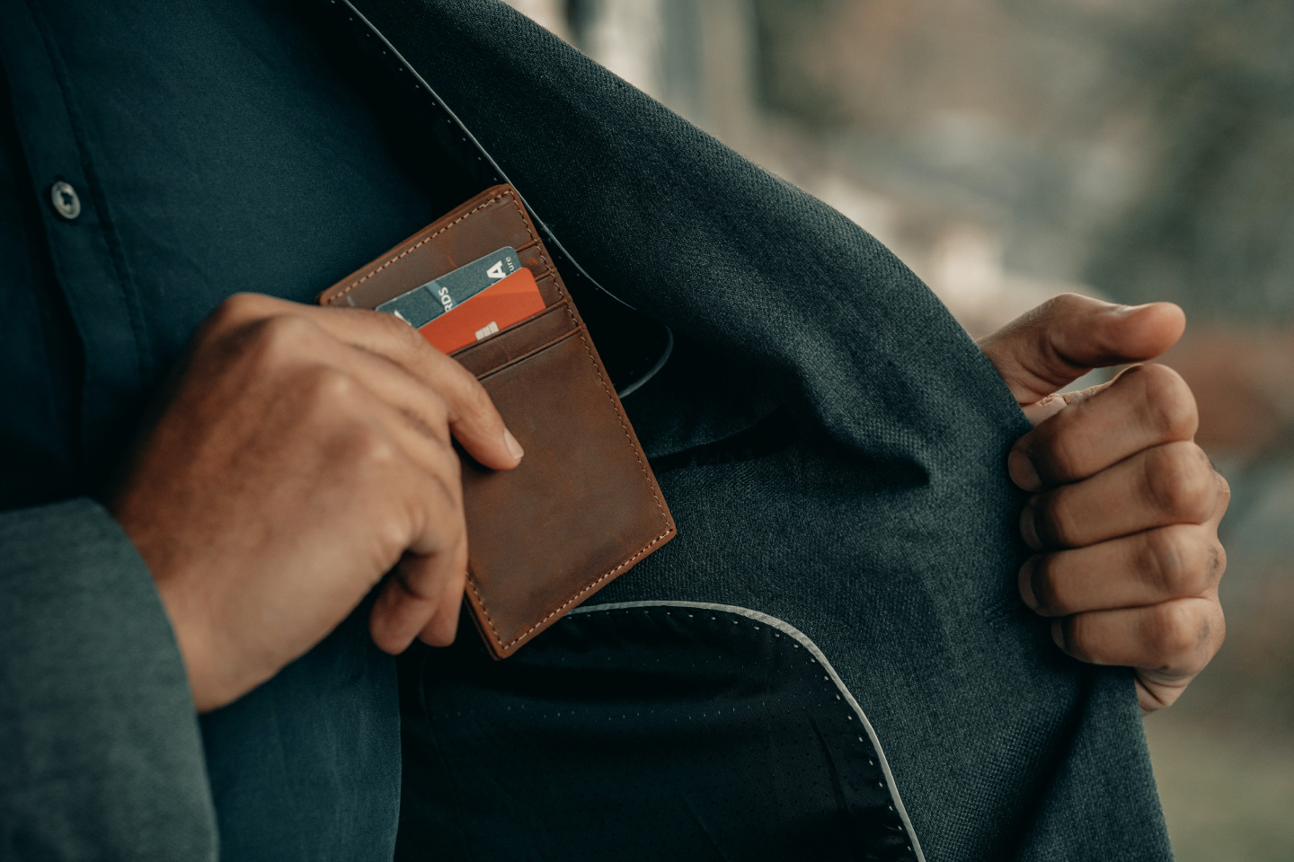 Person putting wallet into pocket to represent their personal banking