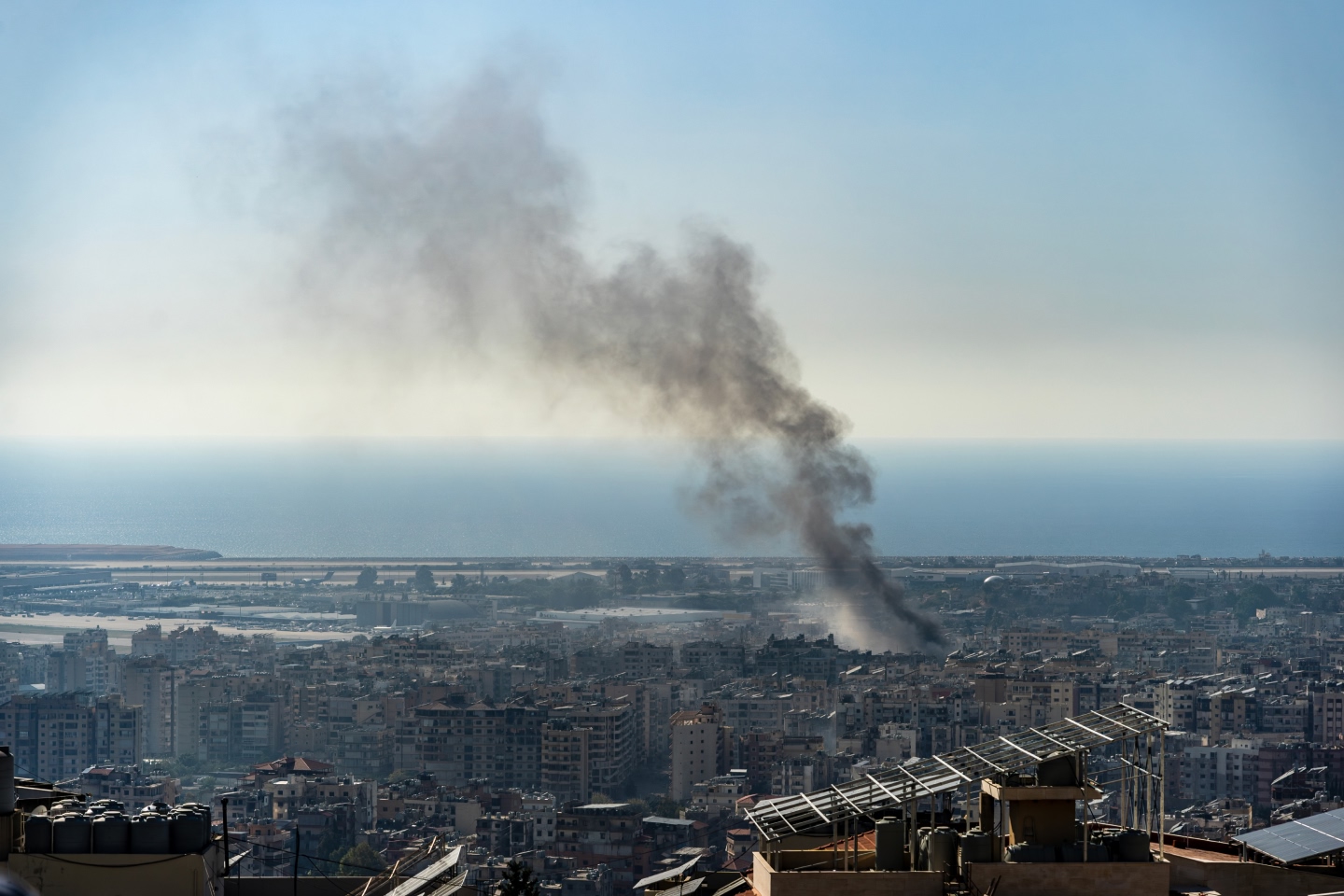 A smoking building representing global geopolitical conflict that has been rife over the past quarter