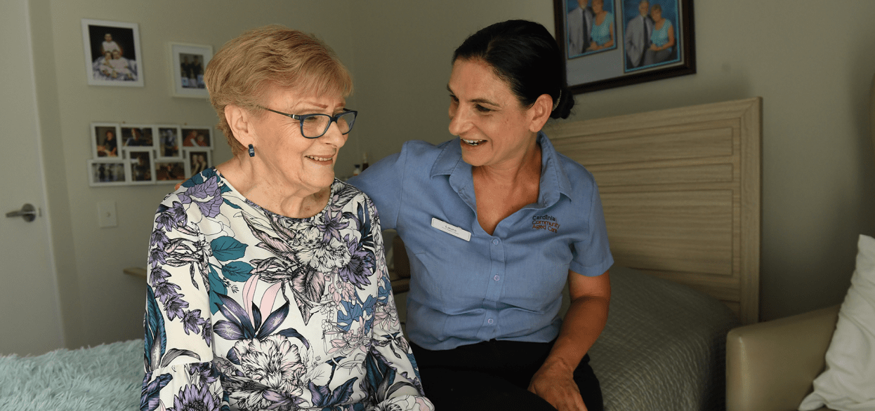 Aged care worker tending to a senior resident, representing investment in For Purpose Aged Care Australia