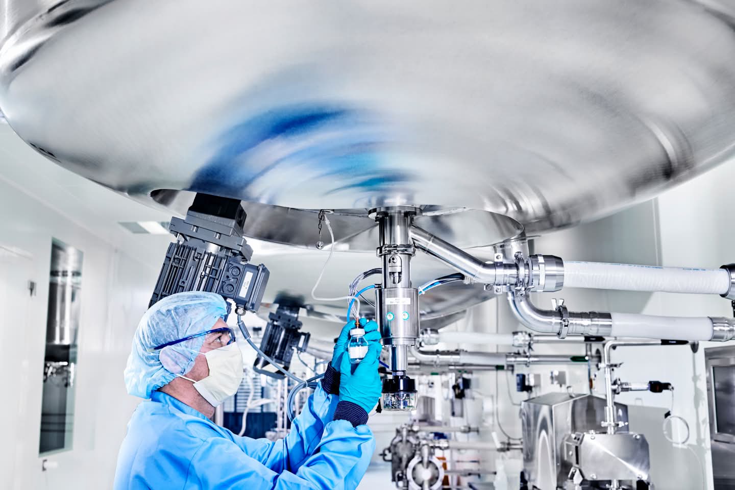Person in hairnet mask and goggles working on technology representing CSL