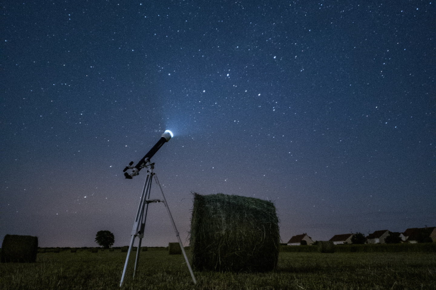 Telescope pointed at a starry night sky indicating our investible universe as expansive and full of potential