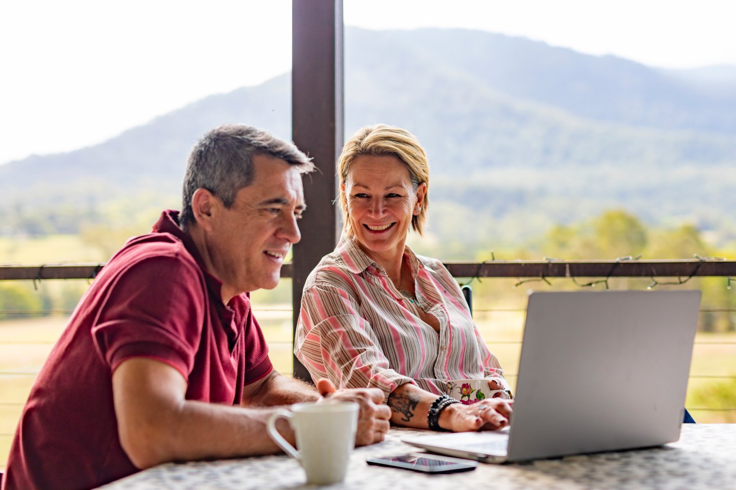 Couple checking super balance on a laptop