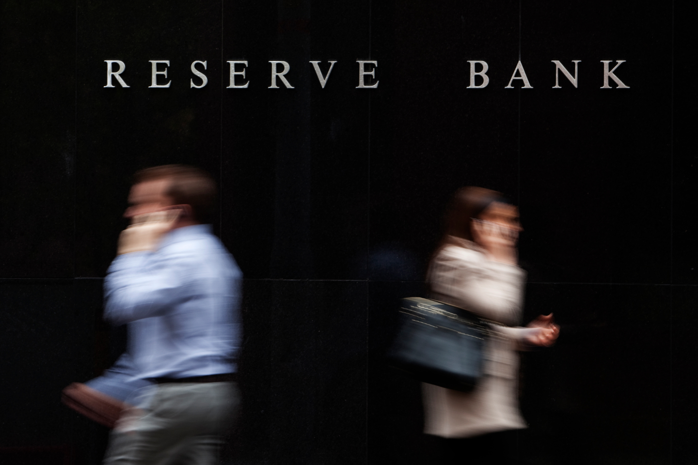 People walking past the Reserve Bank of Australia