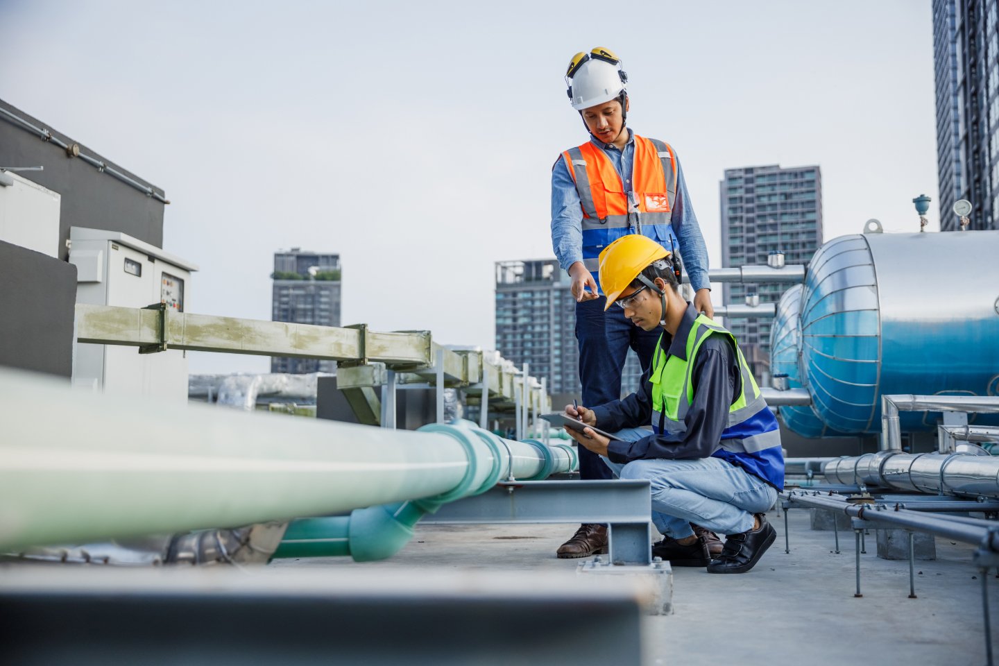 Government tradesmen working on pipes for energy and water supply