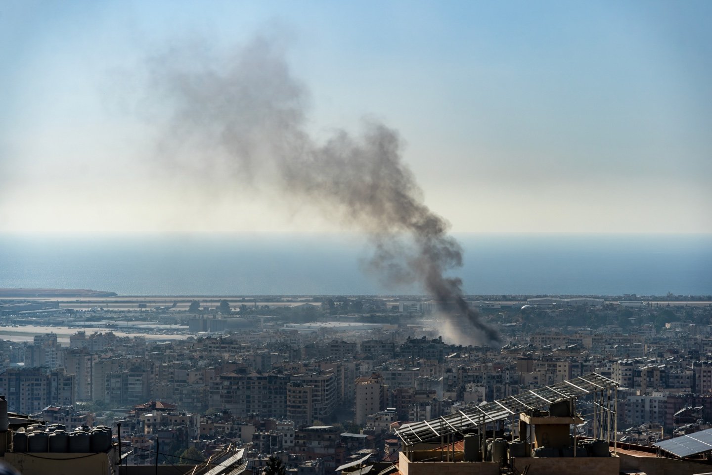 A smoking building representing global geopolitical conflict that has been rife over the past quarter