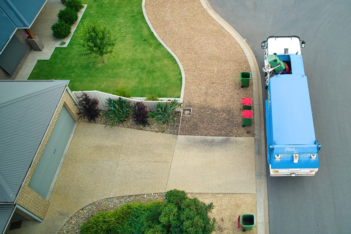 Garbage truck doing Australian rubbish pick up from a suburban house