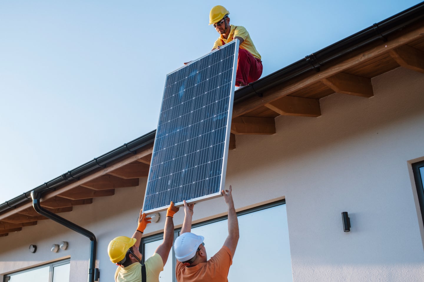 People installing solar panels to represent investment in Brighte Energy