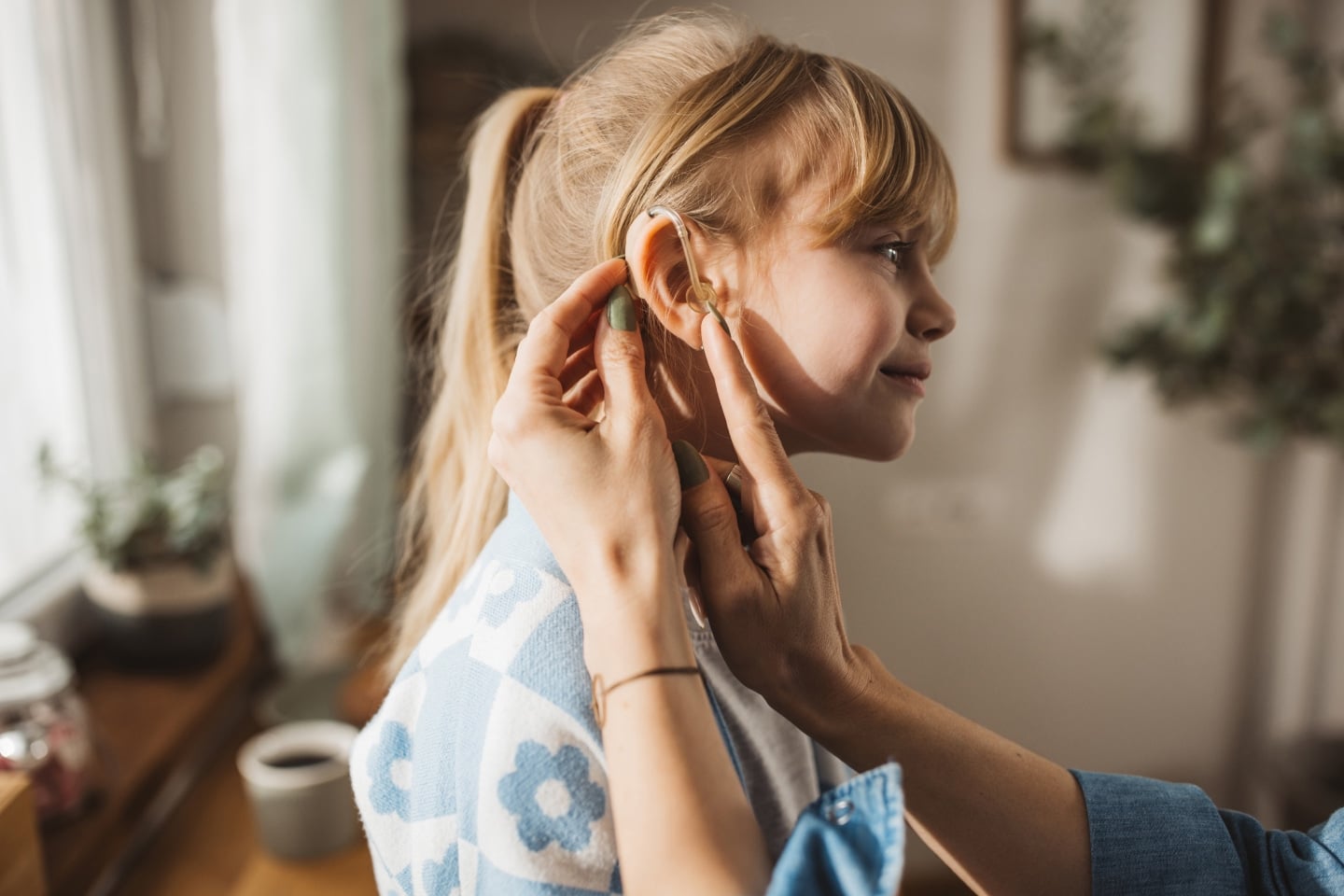 Girl getting fitted for a hearing aid representing investment in Cochlear