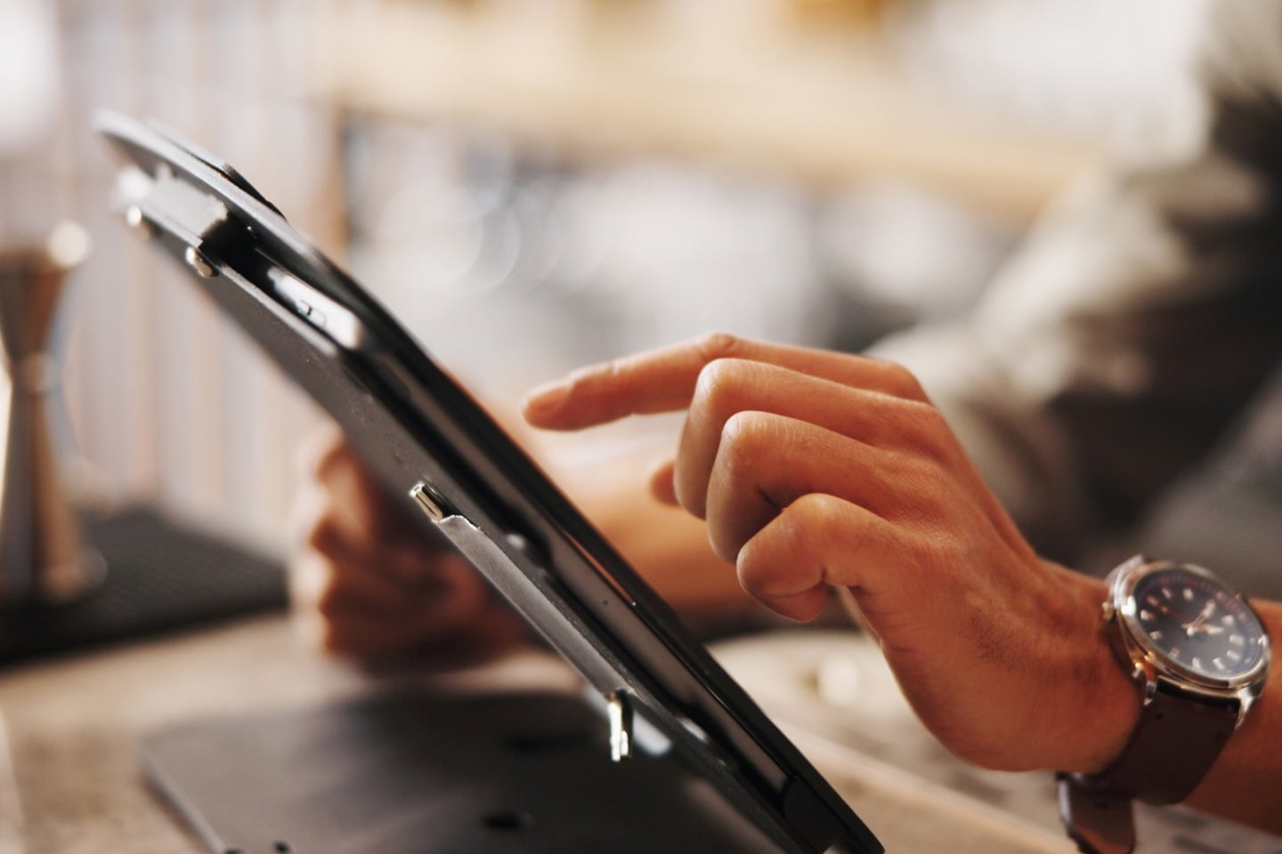 Person on a tablet representing investment in payments and technology
