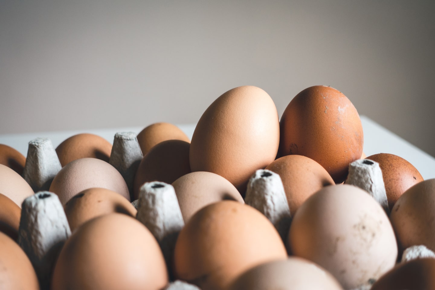 Chicken eggs overflowing from a carton