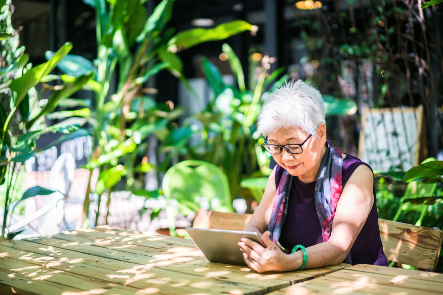 Older lady making a Transition to Retirement plan in a garden