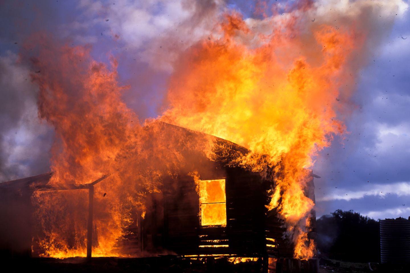 Property on fire in Australia signifying increase in climate related crises making insurance premiums more expensive